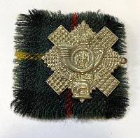WW2 British Highland Light Infantry Cap Badge With Tartan Backing Cloths